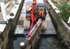 Old lock mitre gates being lifted out at Thames Weir Lock, Brentford, London on the Grand Union Canal.